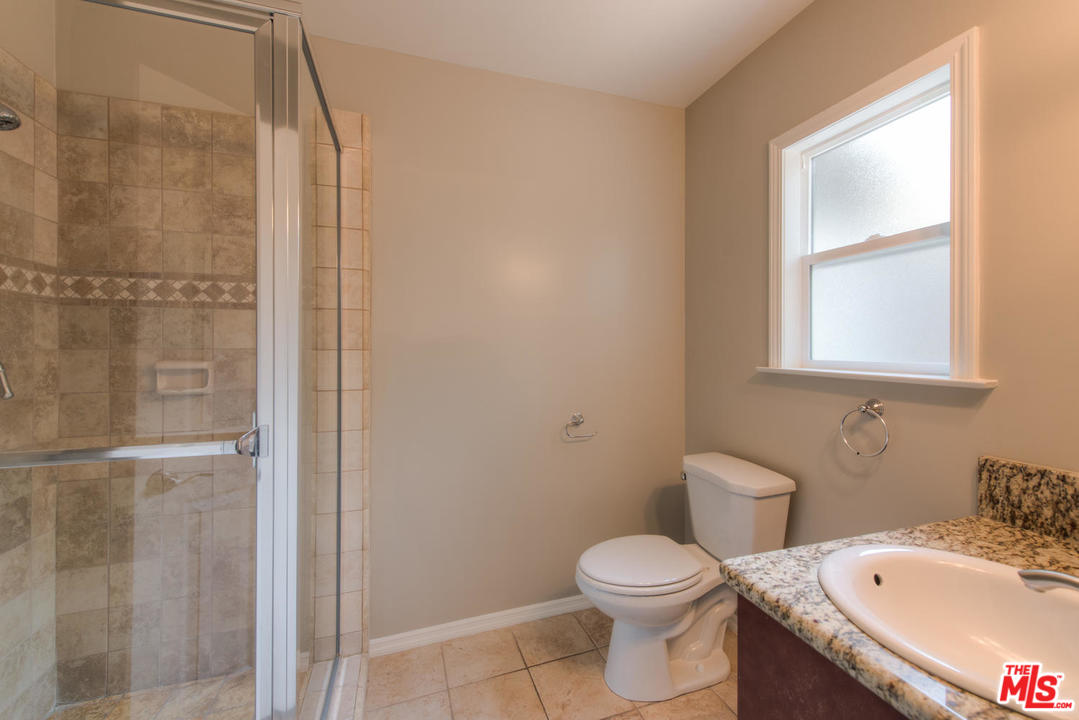 4739 Libbit Avenue Encino, CA 91436 - Photo 16 of 23 a white toilet sitting next to a bathroom sink