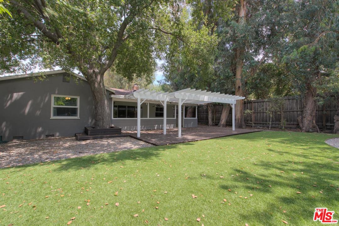 4739 Libbit Avenue Encino, CA 91436 - Photo 19 of 23 a front view of a house with a garden