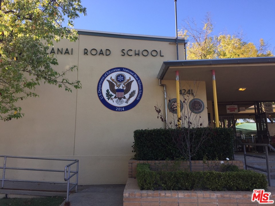 4739 Libbit Avenue Encino, CA 91436 - Photo 23 of 23 a view of a fridge with wooden walls