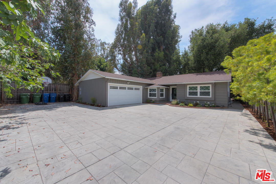 4739 Libbit Avenue Encino, CA 91436 - Photo 3 of 23 a front view of a house with a yard and a garage