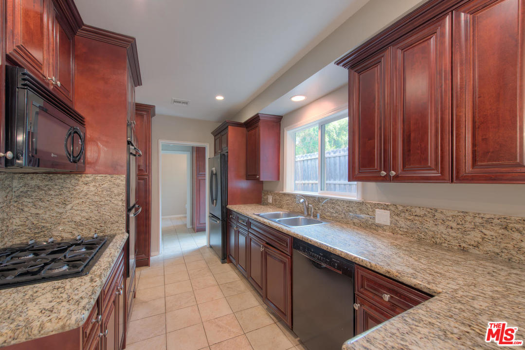 4739 Libbit Avenue Encino, CA 91436 - Photo 6 of 23 a kitchen with a sink stove top oven and cabinets