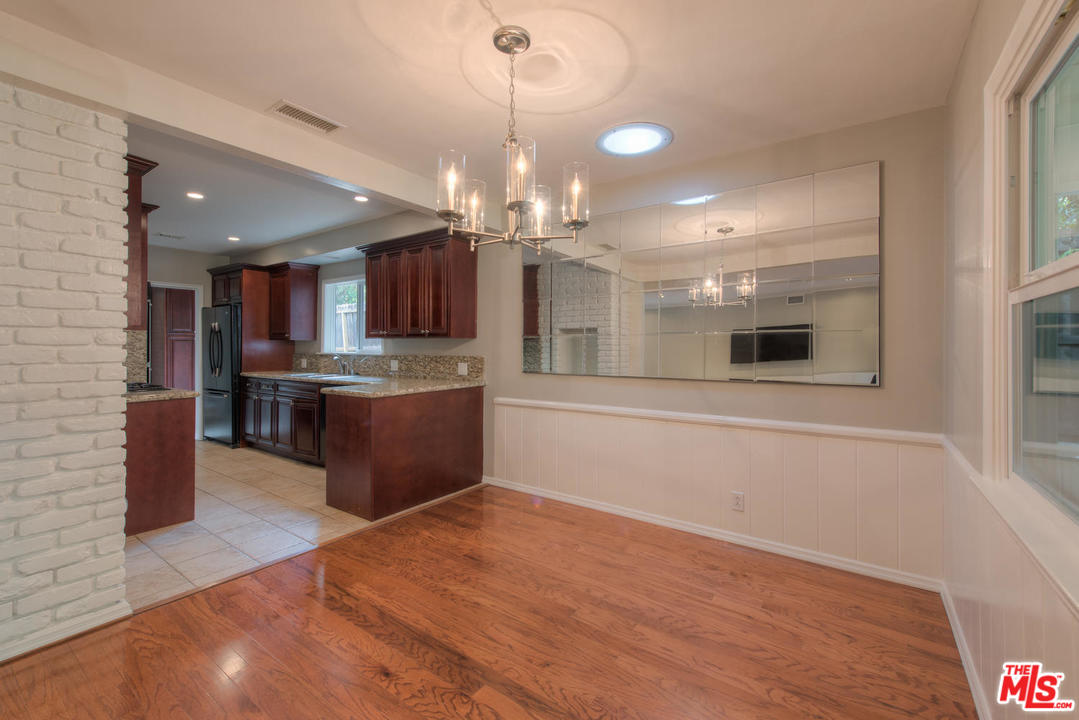 4739 Libbit Avenue Encino, CA 91436 - Photo 9 of 23 a large kitchen with kitchen island a sink wooden floor and stainless steel appliances