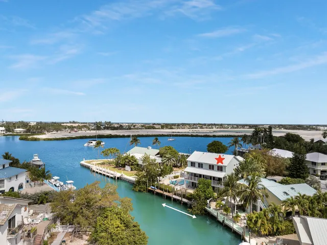 an aerial view of a house with a lake view