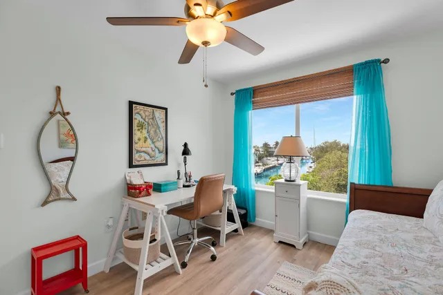 a bedroom with a bed and a painting on the wall