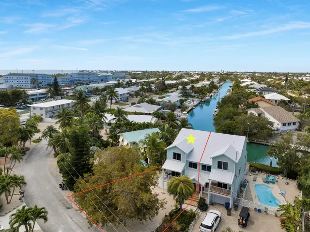 an aerial view of residential house with pool and yard