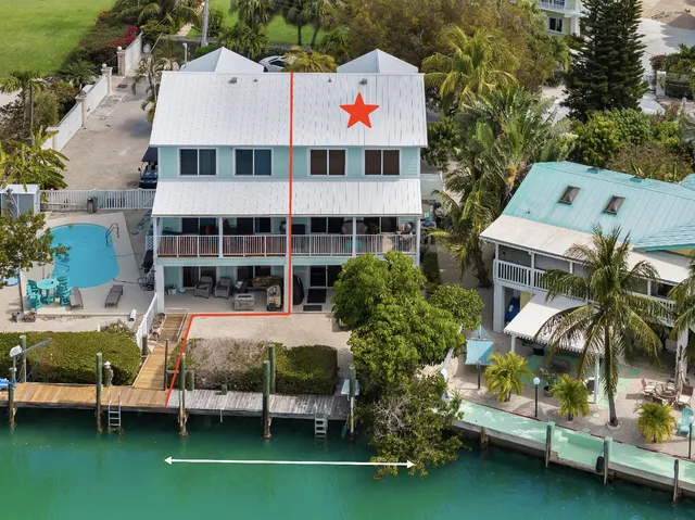 an aerial view of a house with lake view