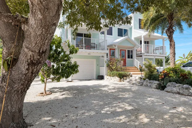 a view of a house with a swimming pool lawn chairs and a yard