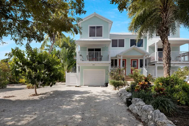 a front view of a house with a yard and a garage