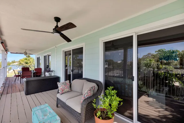 a living room with furniture a flat screen tv and a large window