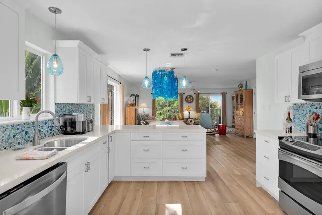 a view of a lake with a yard from a balcony