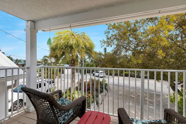 a large kitchen with a wooden floor and white cabinets