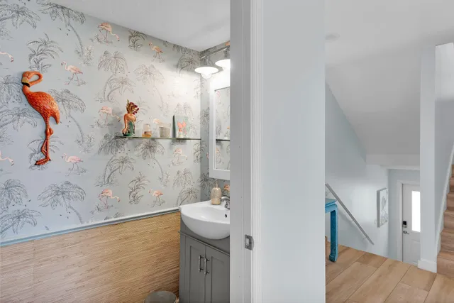 a balcony with wooden floor table and chairs