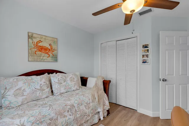 a bedroom with a balcony a bed and a chandelier