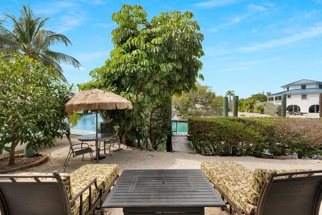 a view of a building with sitting area and furniture