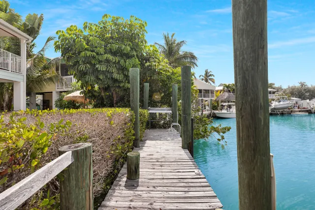 a view of a patio with a table and chairs under an umbrella