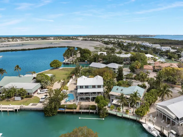 an aerial view of multiple houses with a yard