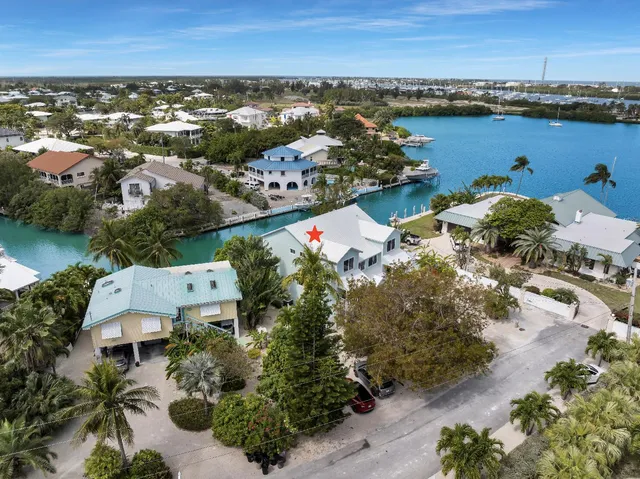 an aerial view of a building with outdoor space swimming pool and ocean view