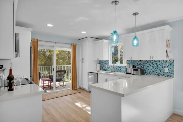 a dining room with furniture a chandelier and wooden floor
