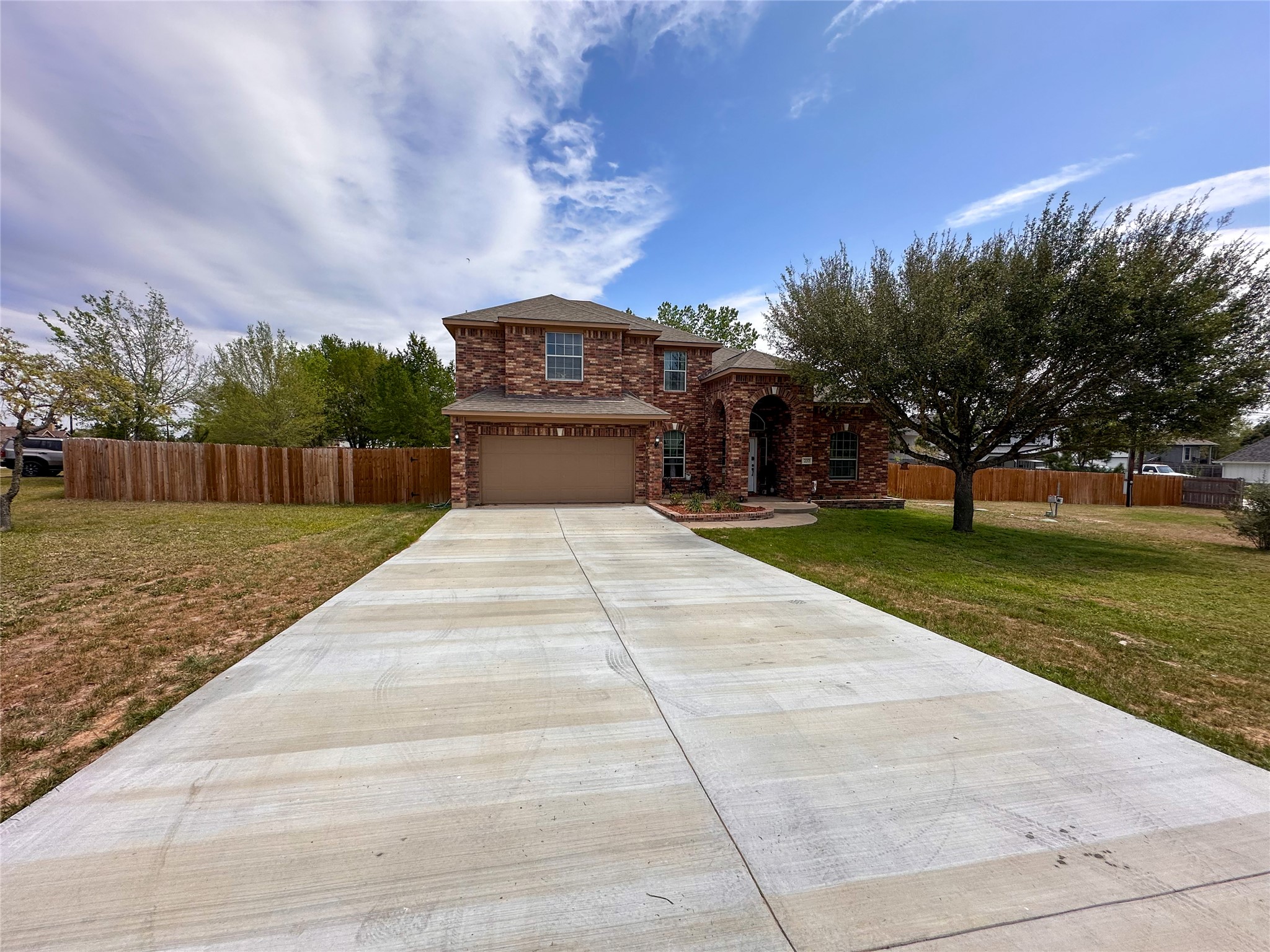 237 Cardinal Drive Paige, TX 78659 - Photo 1 of 37 Traditional home with concrete driveway, stone siding, and a garage