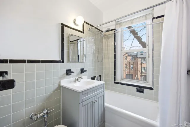 a bathroom with a granite countertop sink a toilet and shower