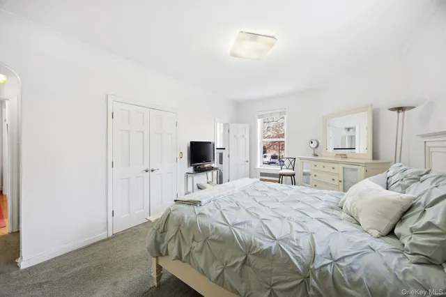 a bedroom with a bed and a television