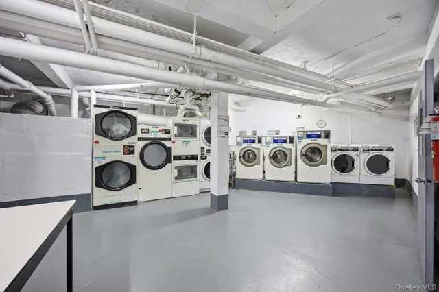 a utility room with multiple dryer and washer