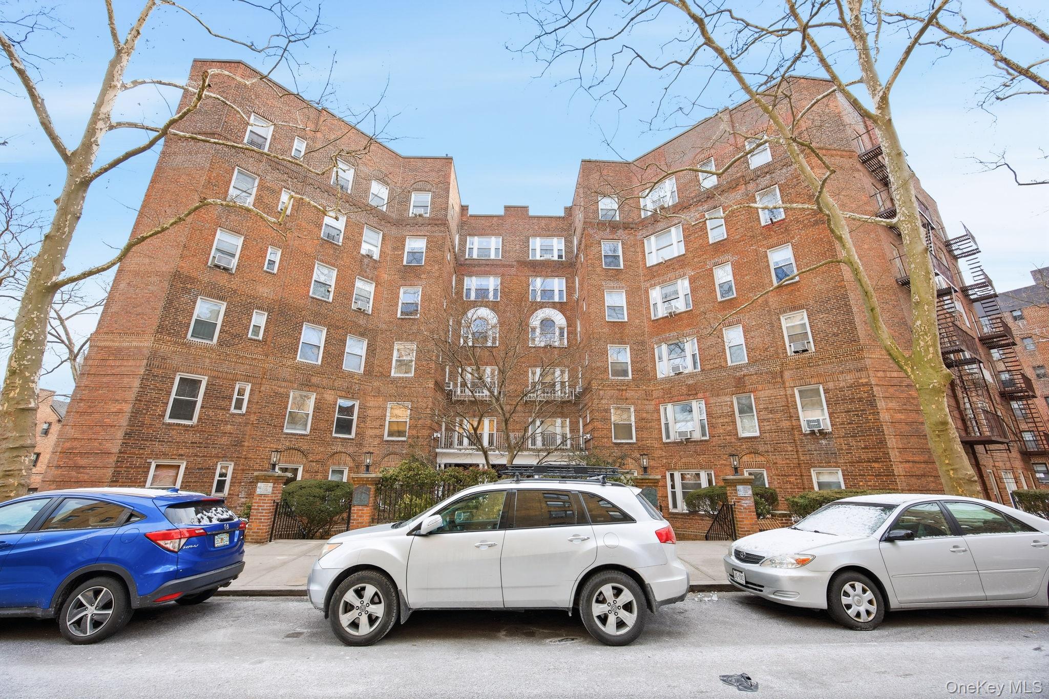 124-16 84th Road, Unit 2E Queens, NY 11415 - Photo 22 of 22 a car parked in front of a building