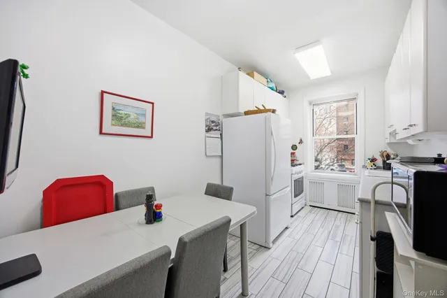 a kitchen with a refrigerator a stove top oven a sink dishwasher and wooden floor