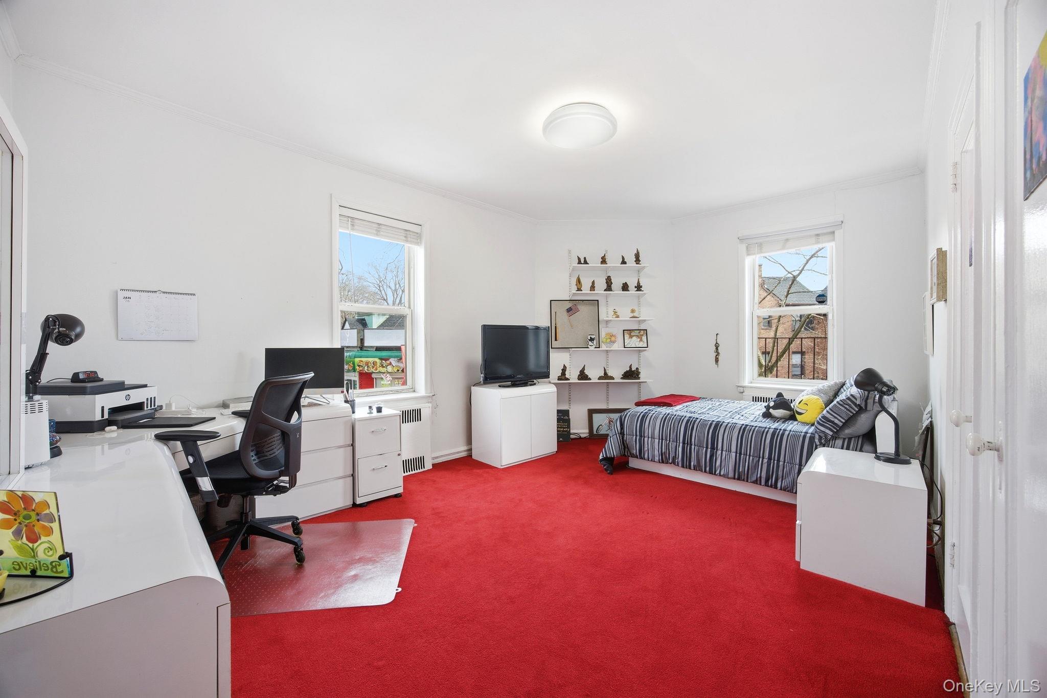 124-16 84th Road, Unit 2E Queens, NY 11415 - Photo 10 of 22 a bedroom with furniture and a bed