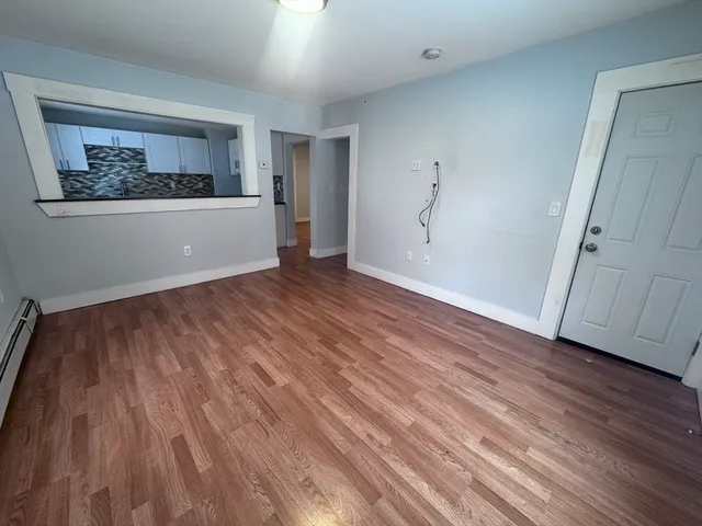 wooden floor in an empty room with a window