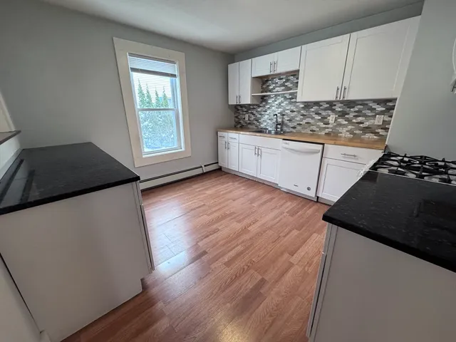 a kitchen with a sink stove and cabinets