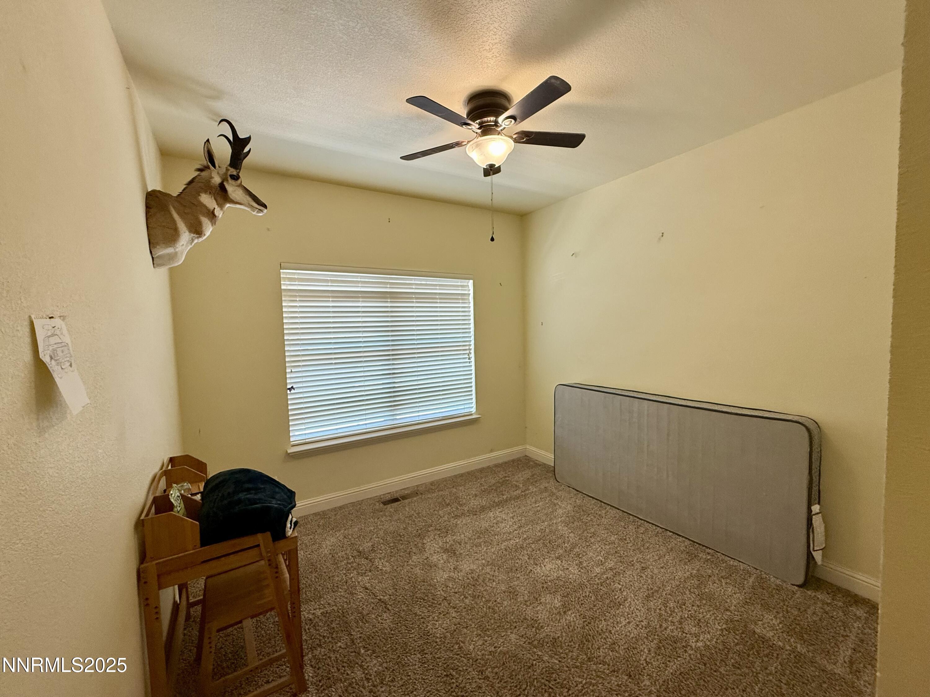 52 Upper Colony Road Wellington, NV 89444 - Photo 11 of 21 a view of a livingroom with a ceiling fan and a window