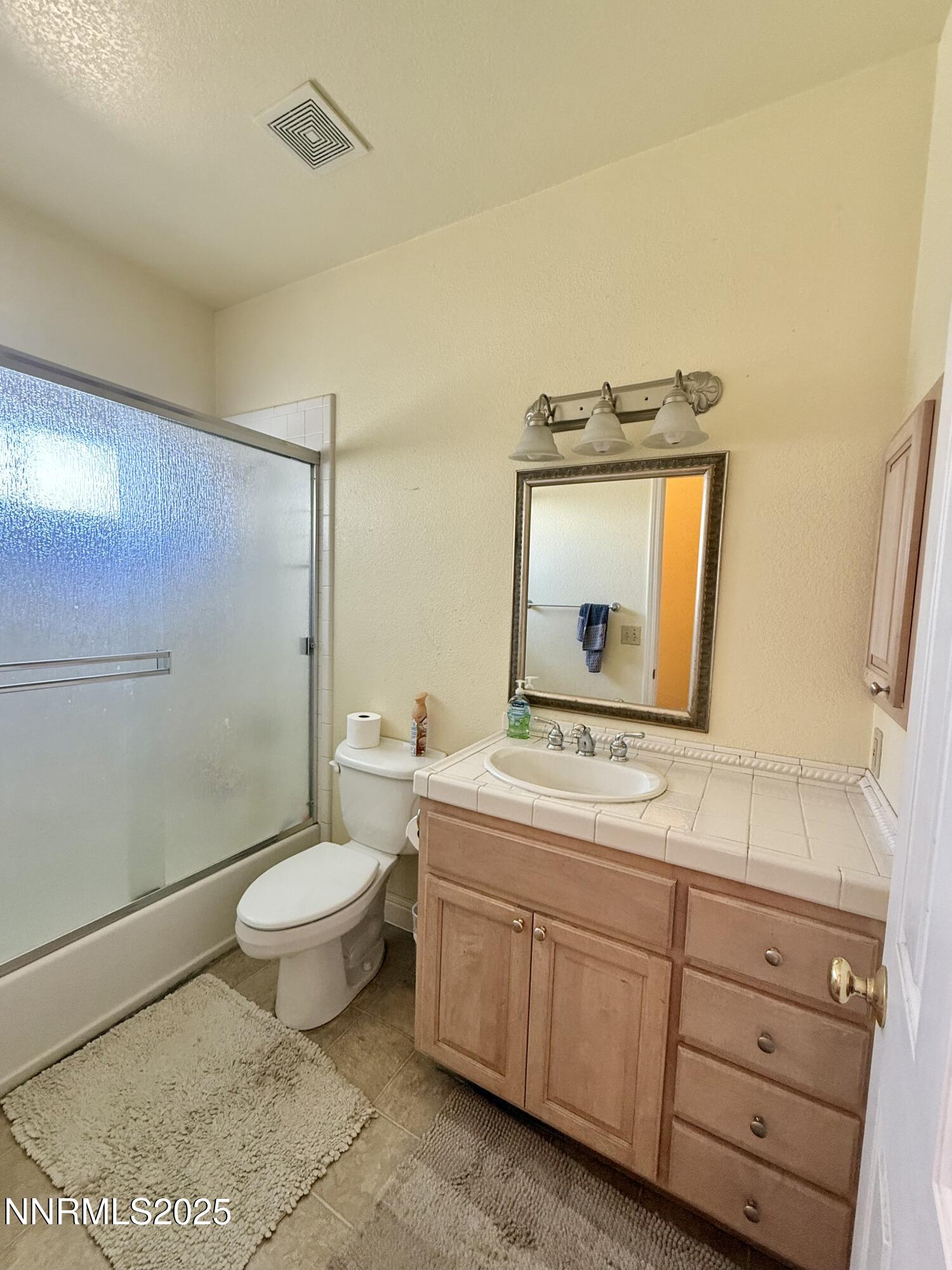52 Upper Colony Road Wellington, NV 89444 - Photo 13 of 21 a bathroom with a toilet a sink and a mirror