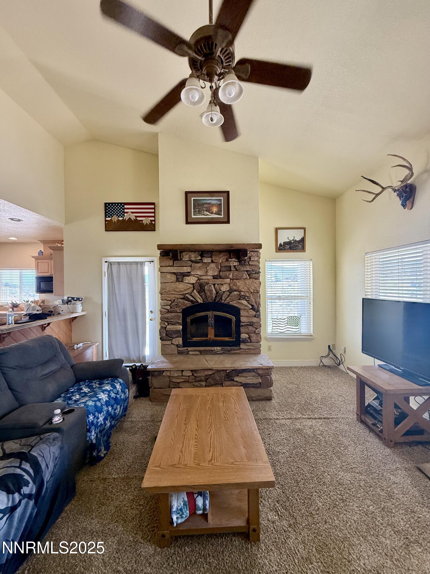 52 Upper Colony Road Wellington, NV 89444 - Photo 4 of 21 a living room with furniture and a fireplace
