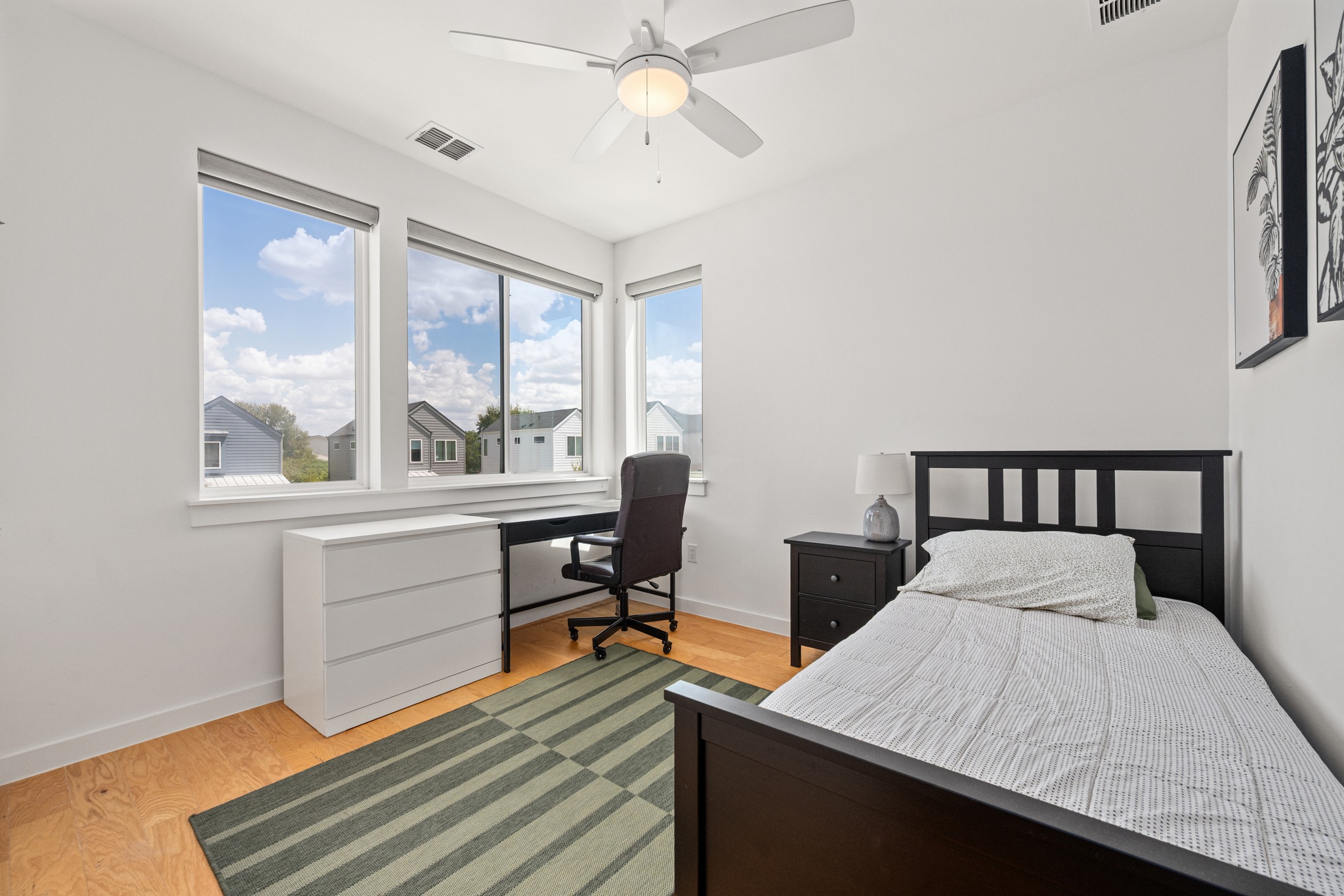 1190 Sarabeth Way Austin, TX 78721 - Photo 14 of 22 Rich wood flooring pairs perfectly with multiple windows overlooking the neighborhood.