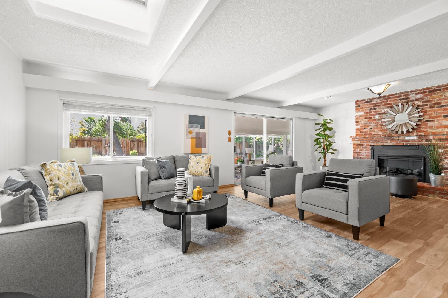 a living room with furniture large window and a fireplace