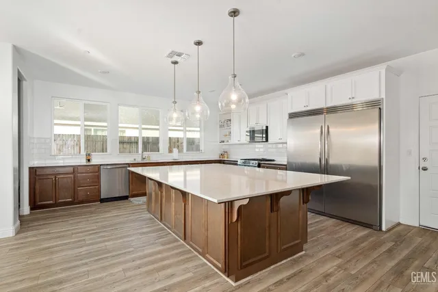 a large kitchen with kitchen island a wooden floor and a counter top space
