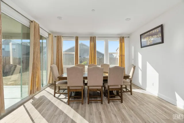 a view of a livingroom with wooden floor and staircase