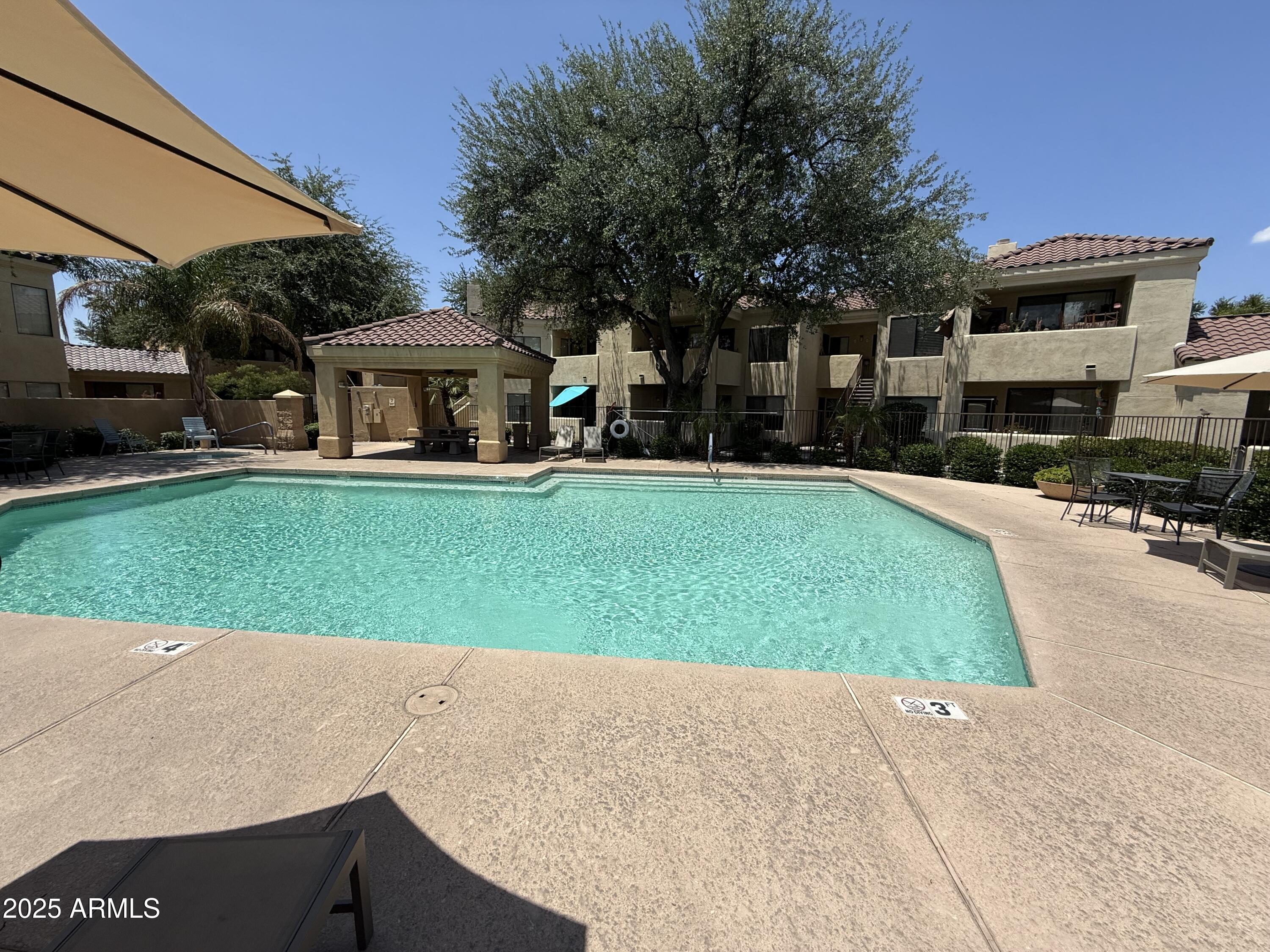 7575 East Indian Bend Road, Unit 2124 Scottsdale, AZ 85250 - Photo 17 of 32 a view of a house with a yard