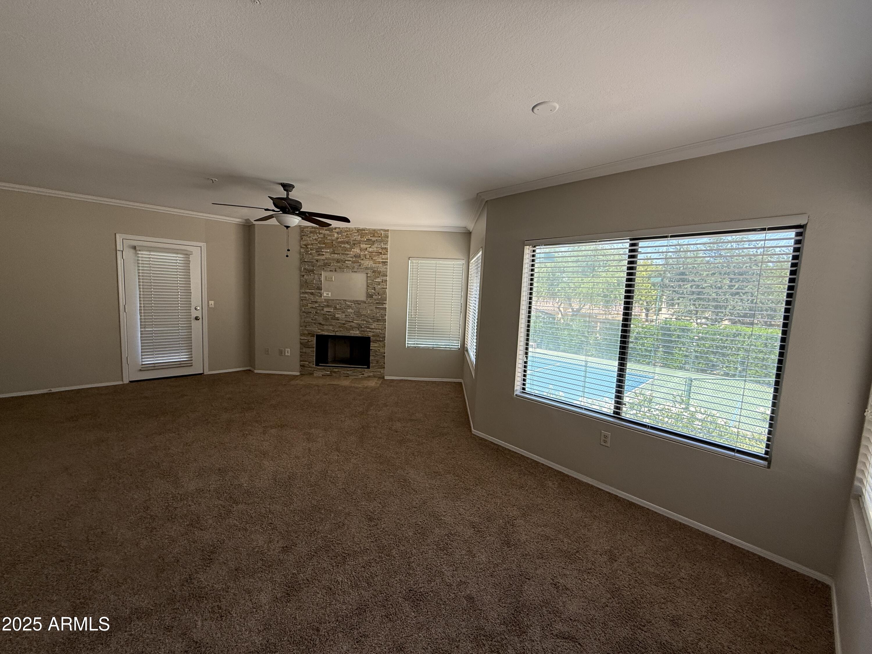 7575 East Indian Bend Road, Unit 2124 Scottsdale, AZ 85250 - Photo 2 of 32 a furnished livingroom with a fireplace and a window