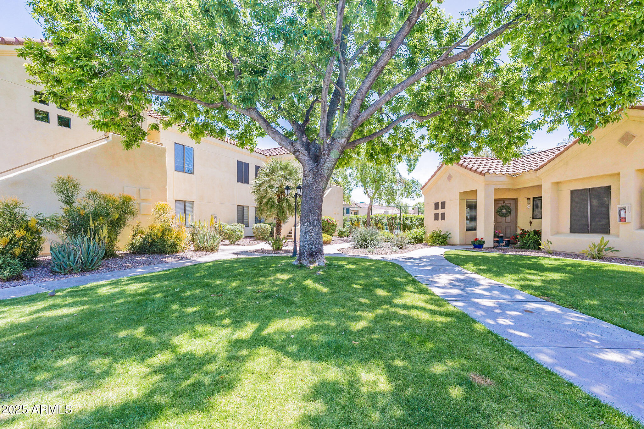 7575 East Indian Bend Road, Unit 2124 Scottsdale, AZ 85250 - Photo 22 of 32 a view of a house with backyard and a tree