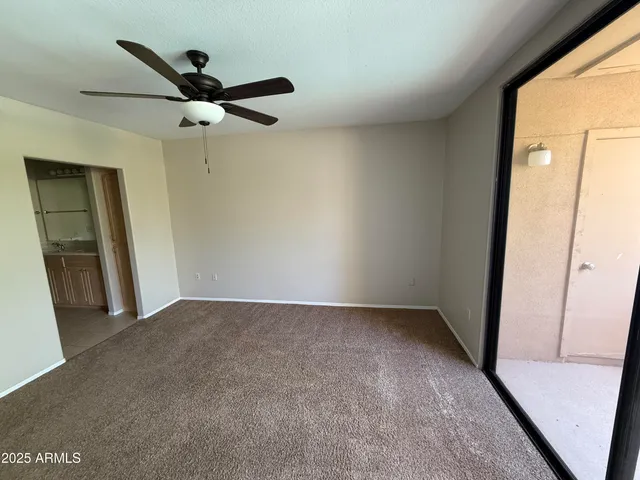 a view of a big room with a ceiling fan