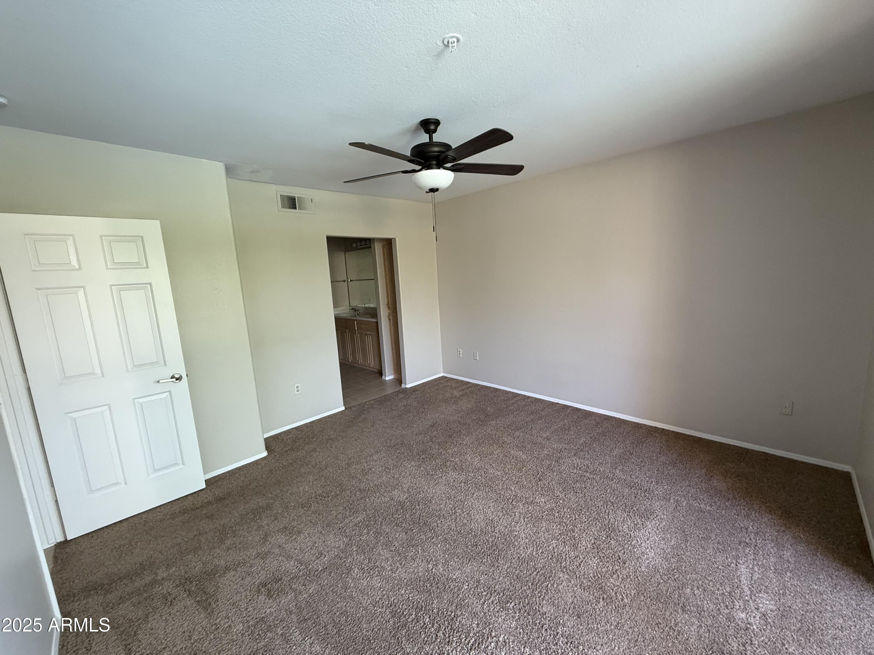 7575 East Indian Bend Road, Unit 2124 Scottsdale, AZ 85250 - Photo 9 of 32 an empty room with a ceiling fan and a window