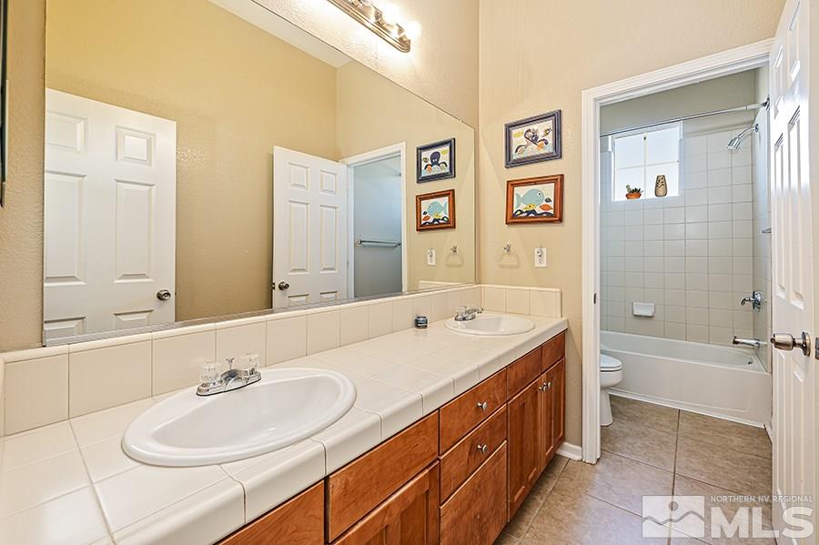 1630 Silver Thread Drive Reno, NV 89521 - Photo 14 of 17 a bathroom with a double vanity sink mirror double and bathtub