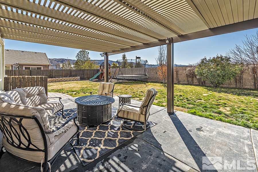 1630 Silver Thread Drive Reno, NV 89521 - Photo 15 of 17 a view of a patio with a dining table and chairs with wooden floor
