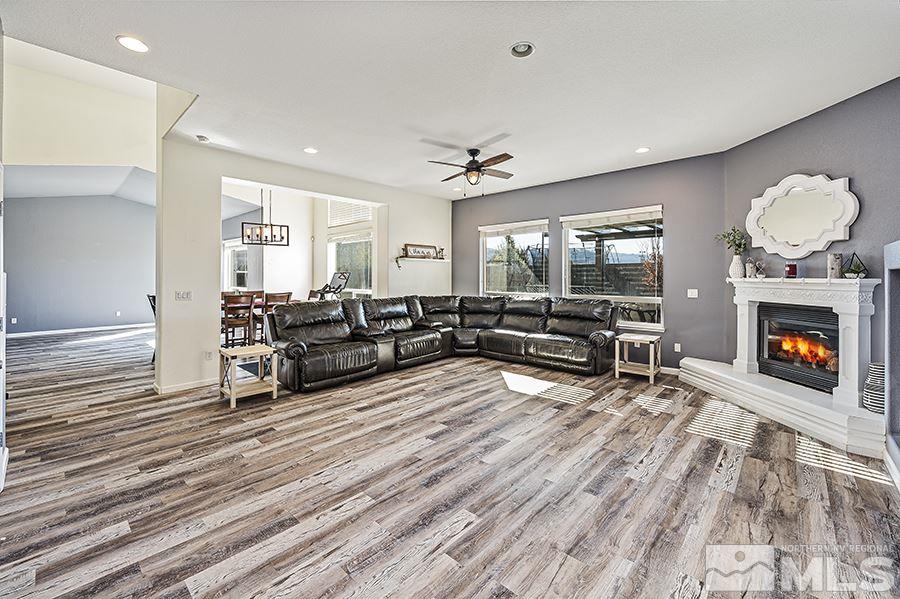 1630 Silver Thread Drive Reno, NV 89521 - Photo 6 of 17 a living room with furniture a fireplace a rug and a window