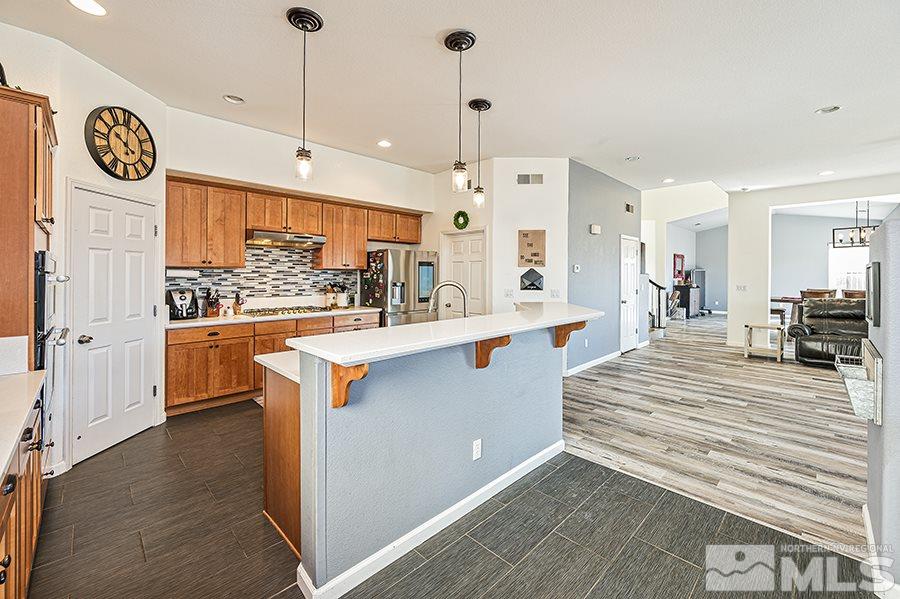 1630 Silver Thread Drive Reno, NV 89521 - Photo 8 of 17 a large white kitchen with a large window a counter space and stainless steel appliances