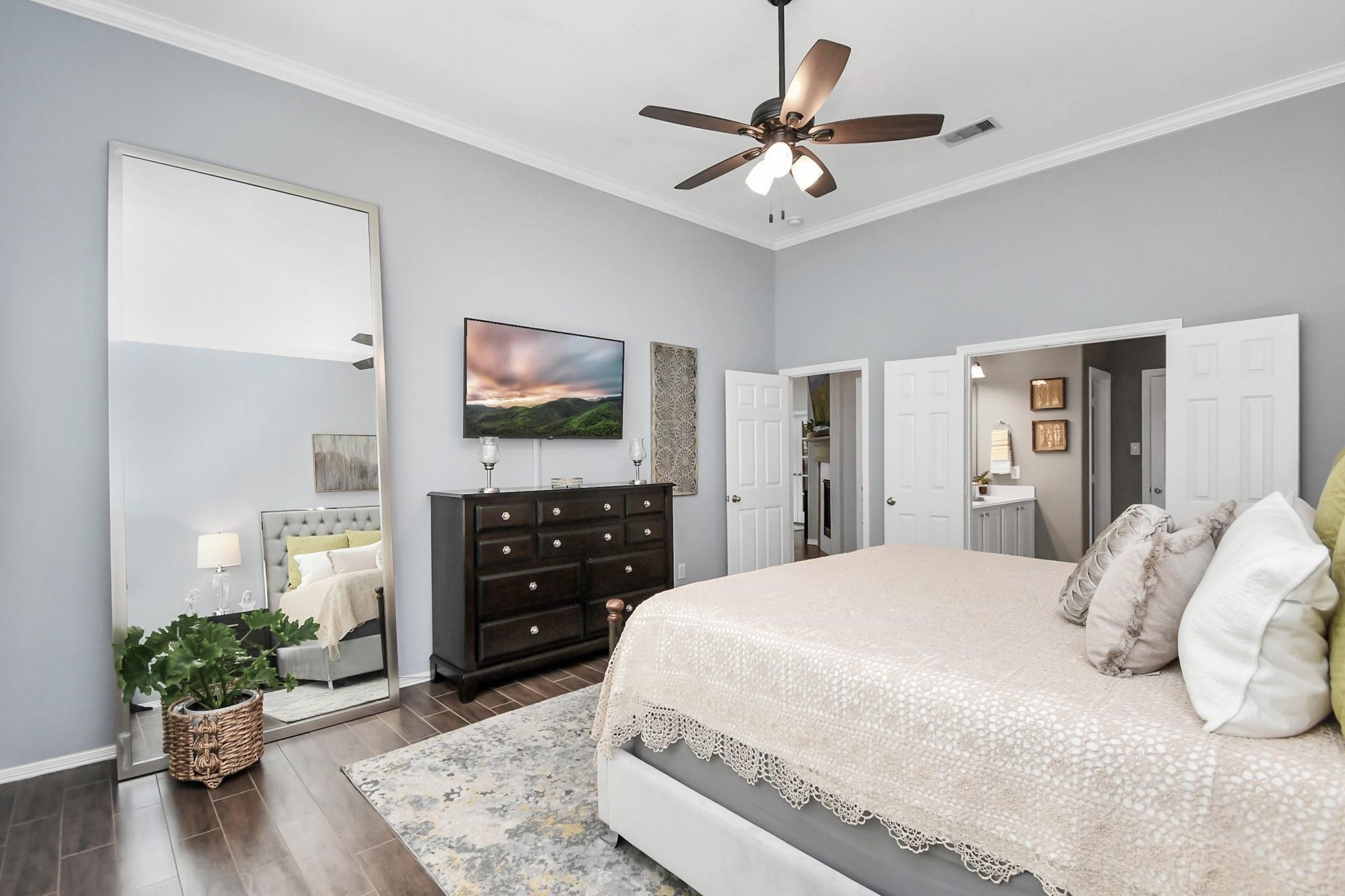 8624 Sunset Loch Drive Spring, TX 77379 - Photo 20 of 44 a spacious bedroom with a bed and a flat screen television
