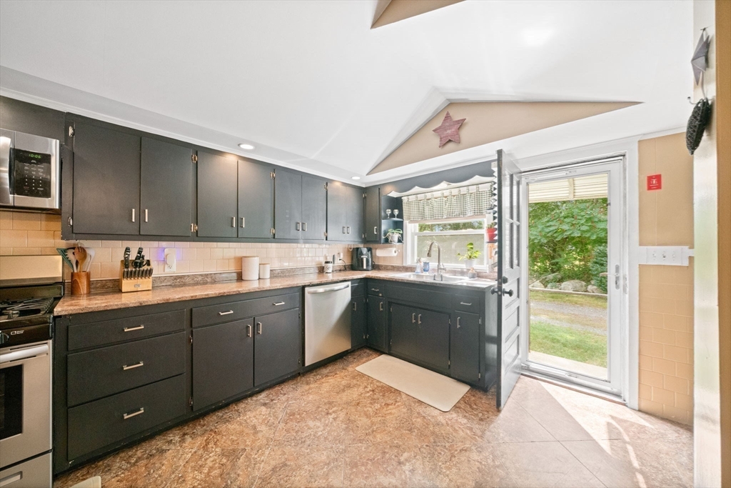 756 Snipatuit Road Rochester, MA 02770 - Photo 5 of 30 a kitchen with stainless steel appliances granite countertop a refrigerator and sink