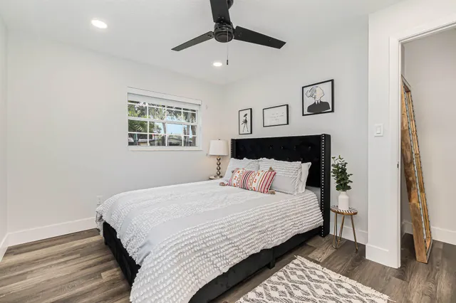 a bedroom with a large bed and a chandelier